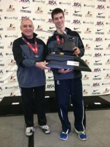 photo of Logan Spear holding Champion Trophy